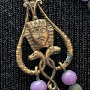 Egyptian themed Vintage earrings in brass with purple beads.